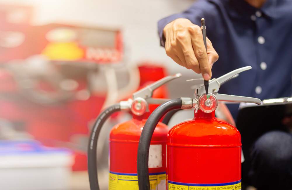 Fire Warden leading vocational HSEQ evacuation training, instructing staff on safe evacuation procedures.