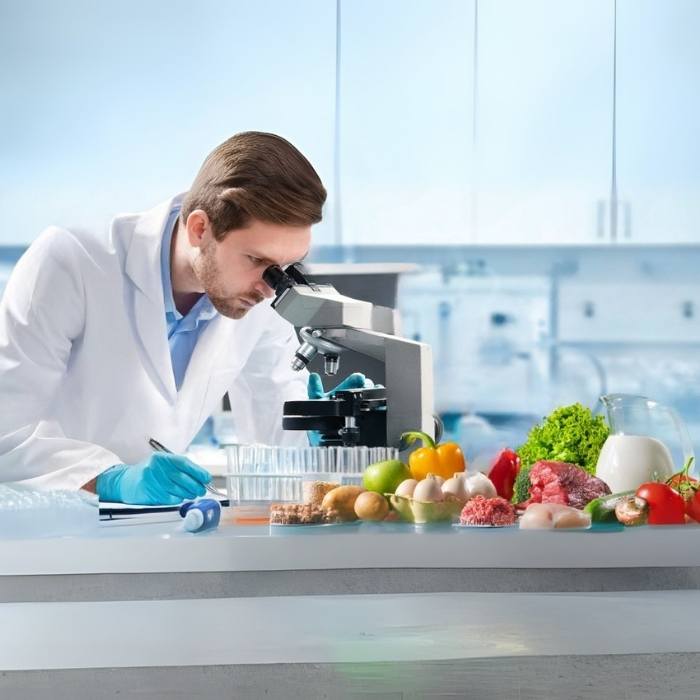 Food safety scientist testing fresh produce, meat, and dairy under a microscope in a laboratory
