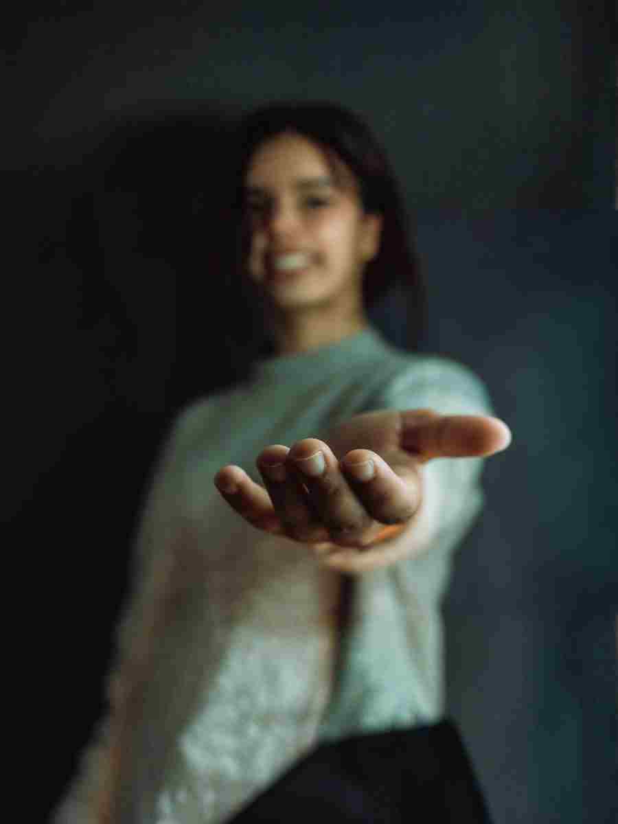 Extending a Hand Support for Mental Health at Work Person extending a hand in a gesture of support and empathy, symbolising mental health awareness in the workplace.